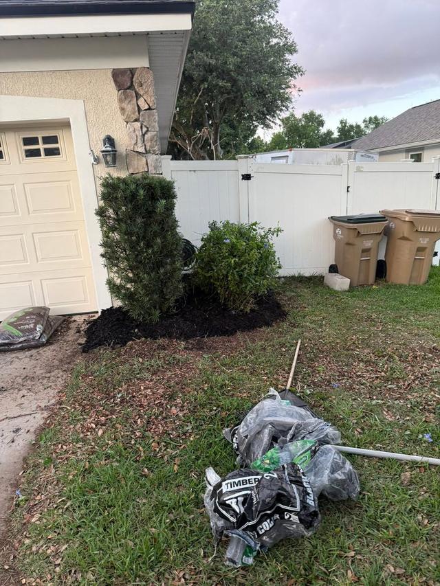 A property being cleaned up with a new bed going in at the front of the house